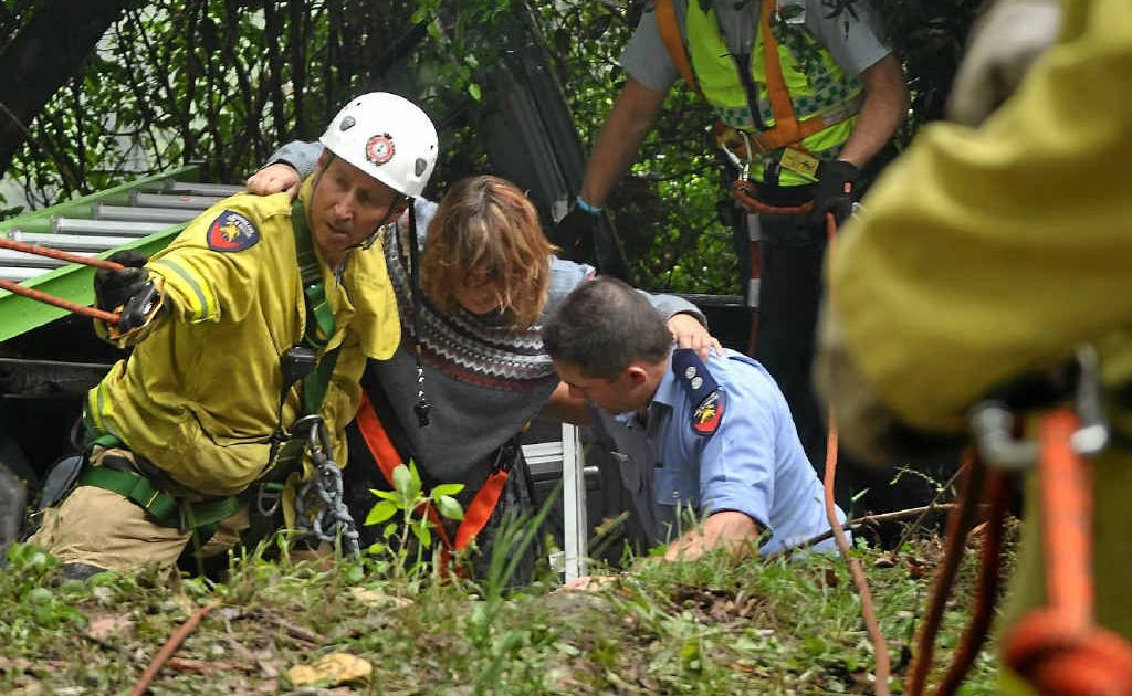 RESCUE: Queensland Fire and Rescue officer Shane Cartwright and paramedics pull the blind 26-year-old Crestmead woman from the wreckage. RESCUE: Queensland Fire and Rescue officer Shane Cartwright and paramedics pull the blind 26-year-old Crestmead woman from the wreckage.